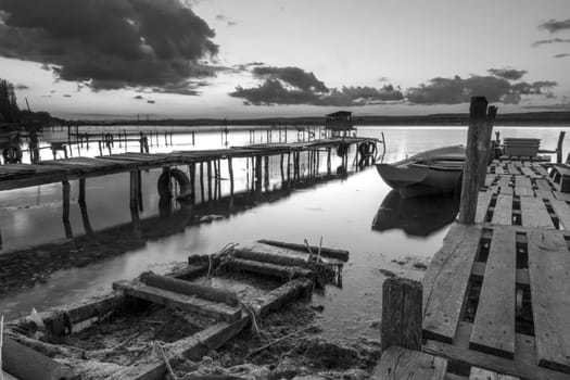 Exciting view on the harbor with wooden piers and boats. Horizontal view