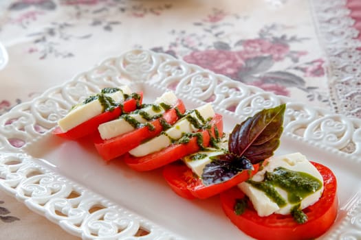 Traditional Italian Caprese salad on the plate. Close view. 