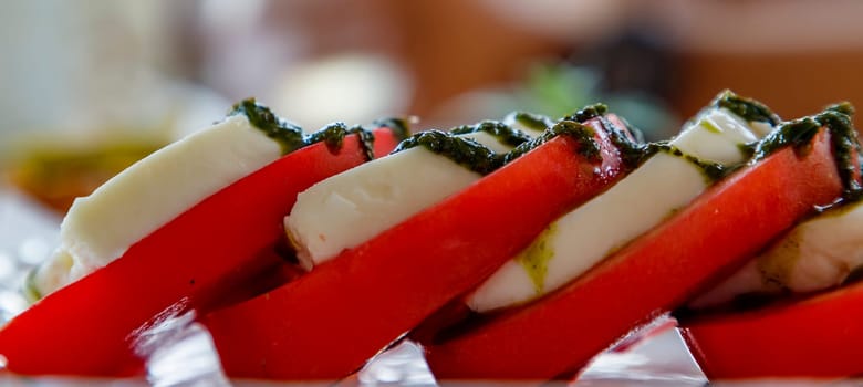 Traditional Italian Caprese salad on the plate. Banner view. 