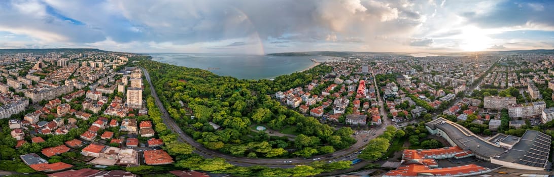 Stunning panorama of the city and rainbow over the sea 