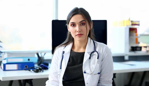 Beautiful smiling female doctor at workplace portrait. Physical and disease prevention patient aid exam visit 911 ward round prescribe remedy healthy lifestyle consultant profession concept