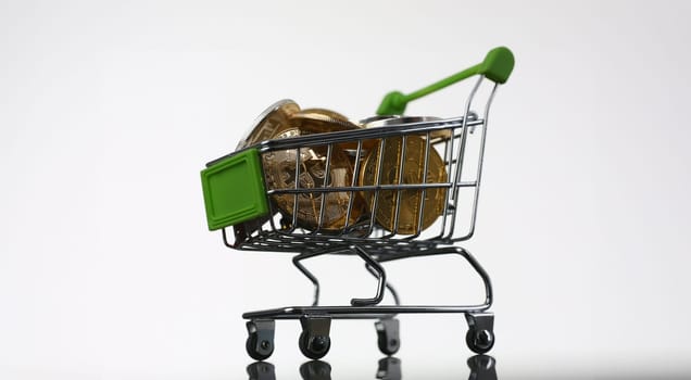 Basket from supermarket with coins crypto currency e bitcoin ethereum litetcoin on a black gray background with reflection exchange purchase sale exchanger closeup.