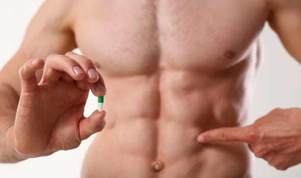 Athlete bodybuilder takes dope in the form of tablets form of pharma rapid progress in muscle development