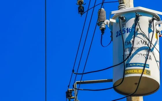 Power pole cable box with blue sky in Zicatela Puerto Escondido Oaxaca Mexico.