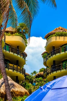 Huge resort and hotel complex on Caribbean beach sea and palm trees in Playa del Carmen Quintana Roo Mexico.