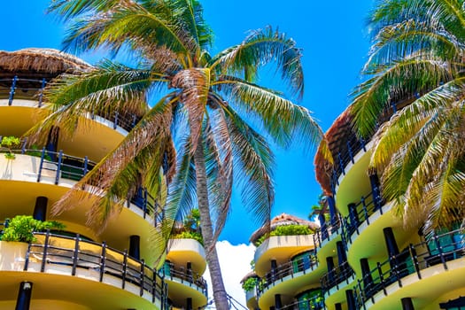 Huge resort and hotel complex on Caribbean beach sea and palm trees in Playa del Carmen Quintana Roo Mexico.