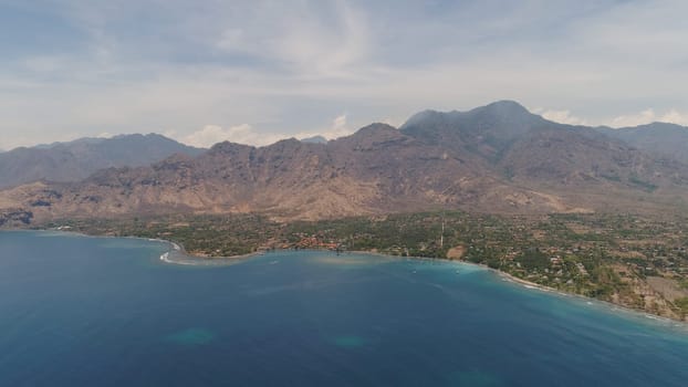 aerial tropical landscape town by sea, mountains, beach, boats on surface water. Bali,Indonesia, travel concept