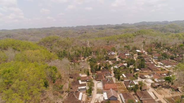 aerial view agricultural landscape in Asia with rice fields and farmland among hills. farmland prepared planting crops. Java Indonesia