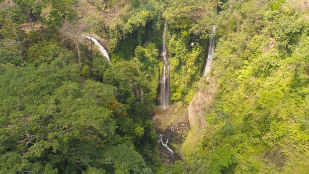 waterfall in green rainforest. Aerial view triple tropical waterfall Sekumpul in mountain jungle. Bali,Indonesia. Travel concept.