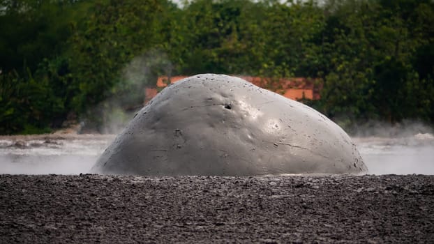 mud volcano with bursting bubble bledug kuwu. volcanic plateau with geothermal activity and geysers, slow motion Indonesia java. volcanic landscape