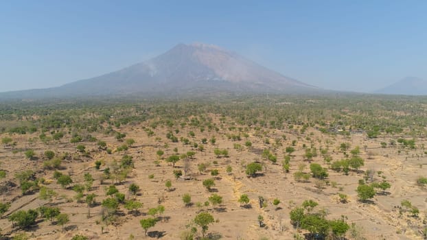 Aerial view volcano mount Agung Bali, Indonesia. tropical landscape savanna with low trees at foot volcano. Rural mountain landscape.