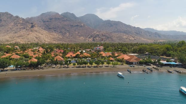 aerial tropical landscape town by sea, mountains, beach, boats on surface water. Bali,Indonesia, travel concept