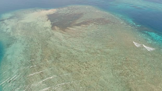 seascape aerial view coral reef, atoll with turquoise water in sea.Tropical atoll, coral reef in ocean waters. Travel concept.