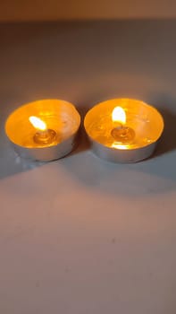 two round candles, fire objects, light . High quality photo