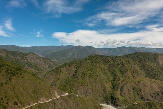 Fresh green foliage, tropical plants and trees covers mountains and ravine. Philippines.