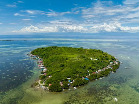 Top view of tropical island with a fishing village. Diutay Island. Philippines.