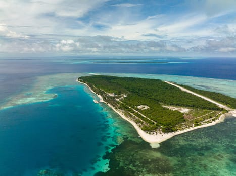 Aerial drone of island with beautiful beach, palm trees by turquoise water view from above. Patongong Island with sandy beach. Balabac, Palawan. Philippines.