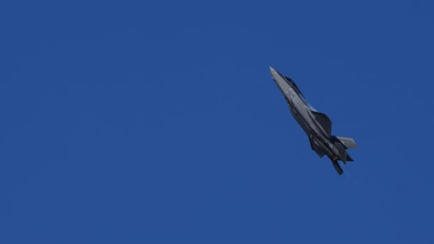 Athens Greece September 3 2023: Modern USAF Fighter Jet Climbing in Blue Sky with Afterburner. Lockheed Martin F-35 Lightning II of United States Air Force. Copy Space