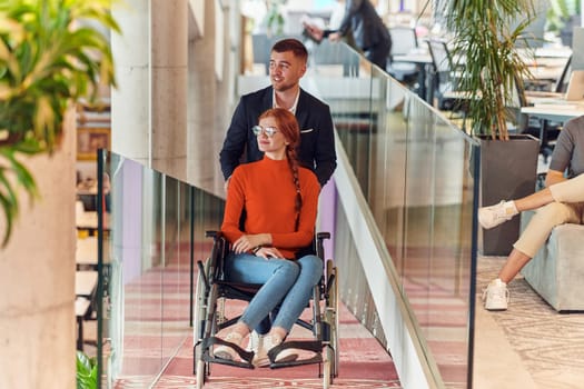 A company director assists his business colleague in a wheelchair, helping her navigate to their startup office, where they work alongside their diverse team of colleagues, emphasizing inclusivity and support in the workplace