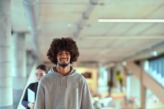 In a modern office environment, an African American young entrepreneur engages in work, while in the background, his dedicated colleagues exemplify teamwork and collaboration, encapsulating the essence of contemporary corporate success.