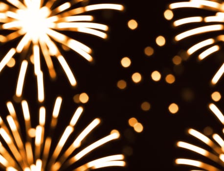 The image is a seamless pattern of golden fireworks in the shape of a circle. - seamless and tileable