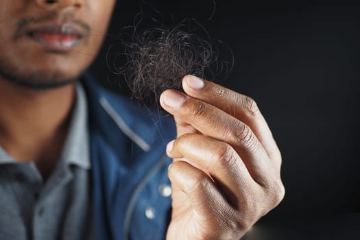 man hold his list hair close up ,