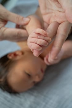 A newborn boy holds his mother's finger. Close-up of hands