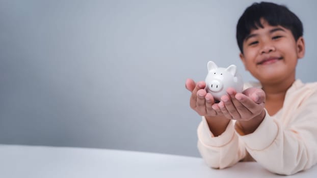 A boy holding piggy bank. Learning financial responsibility and projecting savings. savings concept. investment concept.