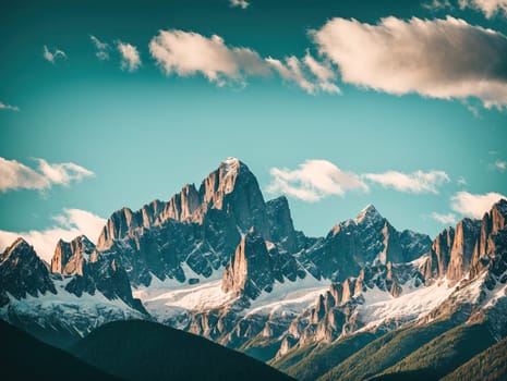 The image shows a mountain range with snow covered peaks and clouds in the background.