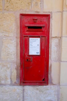 Valletta, Malta, April 03, 2024. an old red postbox in a street in the city center