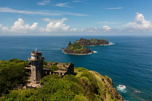 Aerial view of Lighthouse and tropical islands on the background of the blue ocean. Cape Engano. Palaui Island. Santa Ana Philippines.