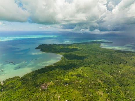 Aerial view of island with jungle and blue sea. Seascape in the tropics. Balabac, Palawan. Philippines.