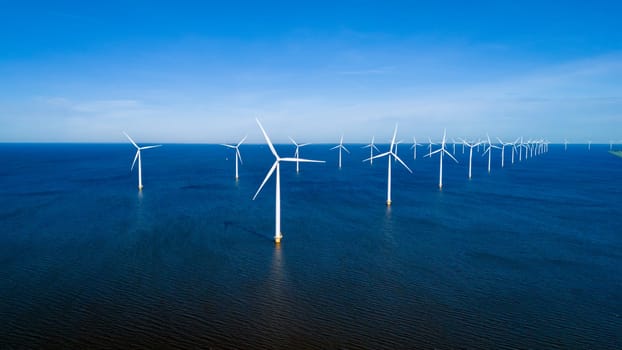 A group of wind turbines stand tall in the ocean, harnessing the power of the wind to generate clean energy for the Netherlands.