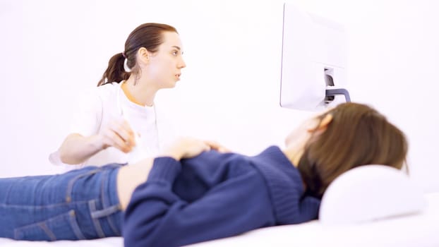 Female doctor performing an ultrasound on a woman in the clinic