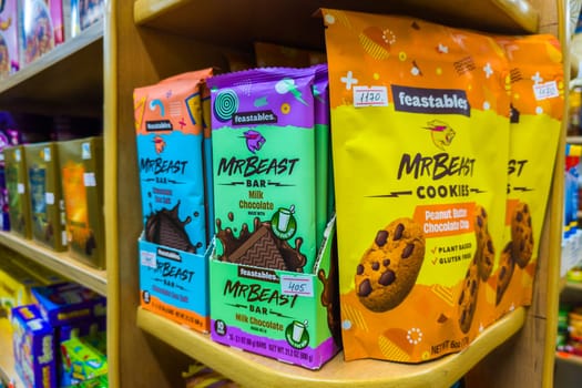 Sokuluk, Kyrgyzstan - April 5, 2024: Chocolate bars and cookies by Mr Beast on small store shelf, his company called Feastables that makes these and other treats