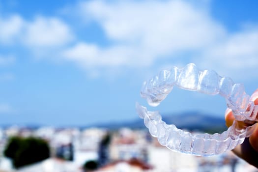 Invisible teeth aligner on light background. No people