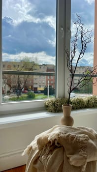 Part of the decoration in the interior, a vase and a view of the city from the window. High quality photo