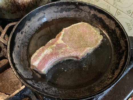 Fried and braised pork steak in a the thefrying pan
