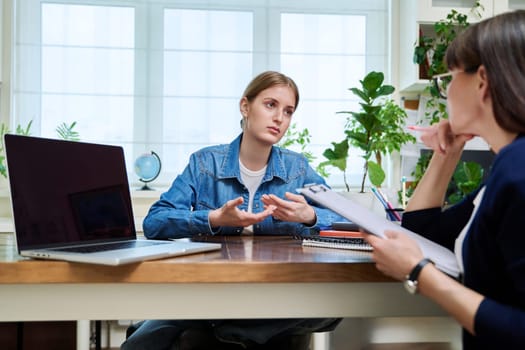 Young teenage girl high school student patient talking with psychologist, therapist, counsellor, social worker. Mental session therapy, support, psychology, psychotherapy, adolescence, youth concept