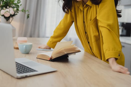 Businesswoman working at home on paperwork.