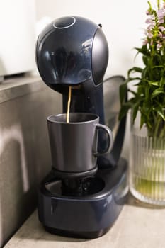 Close-up of espresso pouring from coffee machine. Professional coffee brewing.