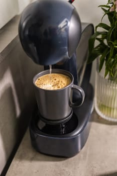 Close-up of espresso pouring from coffee machine. Professional coffee brewing.