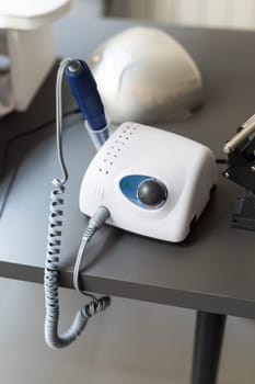 Electric manicure machine on table. Drill for manicure.