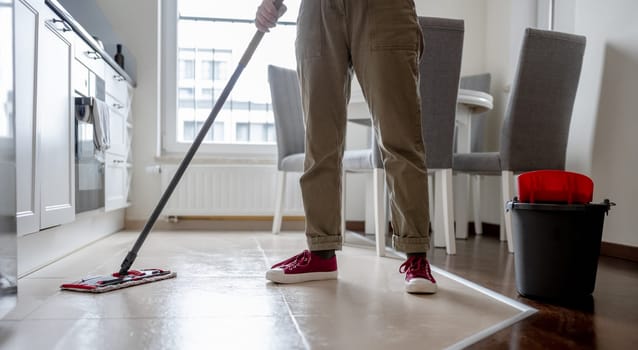 Woman Mops Kitchen Floor With Mop