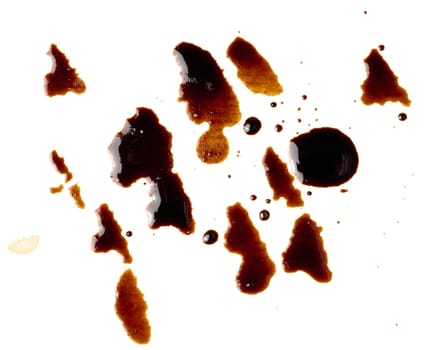 Spilled black coffee, splashes on a white background, close up