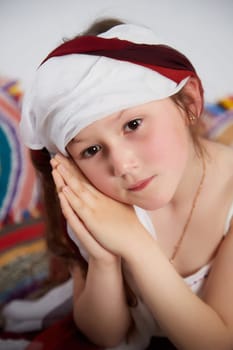 Portrait of Little girl in a stylized Tatar national costume on a white background in the studio. Photo shoot of funny young teenager who is not a professional model