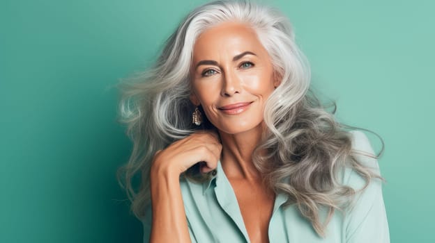 Elegant, elderly, chic latino, Spain woman with gray long hair and perfect skin, green background, banner. Advertising of cosmetic products, spa treatments, shampoos and hair care products, dentistry and medicine, perfumes and cosmetology for women