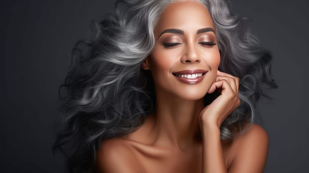 Elegant, elderly, chic latino, Spain woman with gray long hair and perfect skin, gray background, banner. Advertising of cosmetic products, spa treatments, shampoos and hair care products, dentistry and medicine, perfumes and cosmetology for women