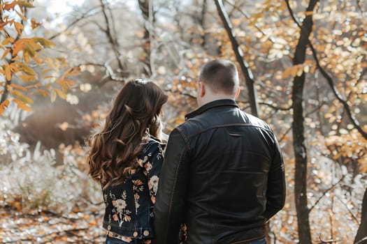 Romantic scene as man proposes to woman in beautiful autumn forest setting, capturing love and engagement in nature.