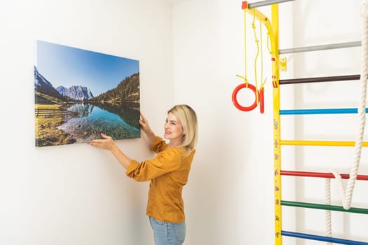 Young woman in yellow blouse hold canvas. Minimal art concept